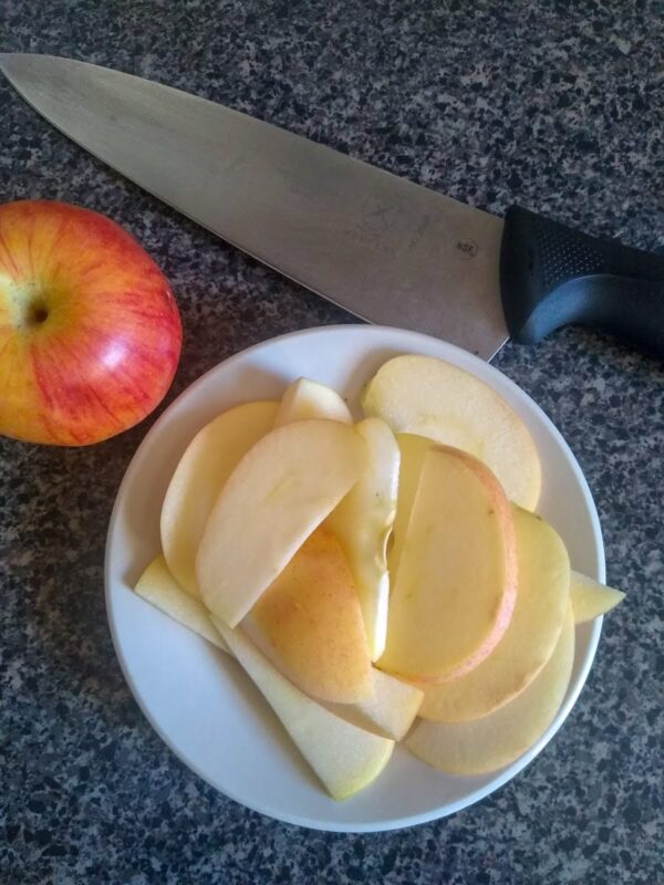 Sliced apples make good treats for the Tower of Cups puzzle for horses.