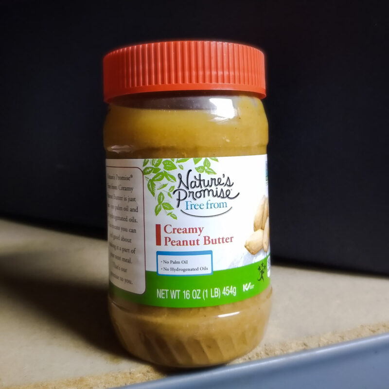 Creamy natural Nature's Promise peanut butter in jar. 