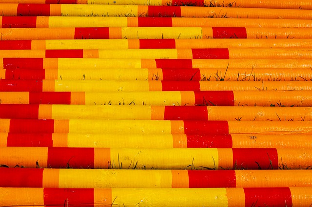 A set of yellow, orange, and red jump poles for horses