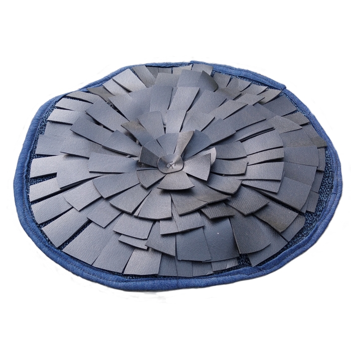 A round snuffle mat for horses made of sturdy blue denim and black vinyl.