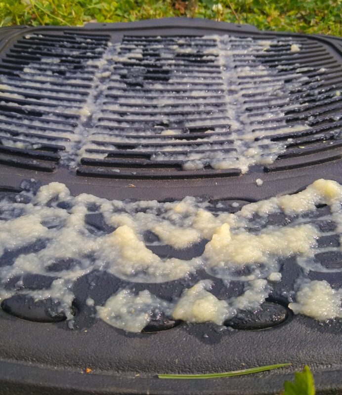 The car floor mat feeder covered in applesauce, close up, to be used as a licking mat.