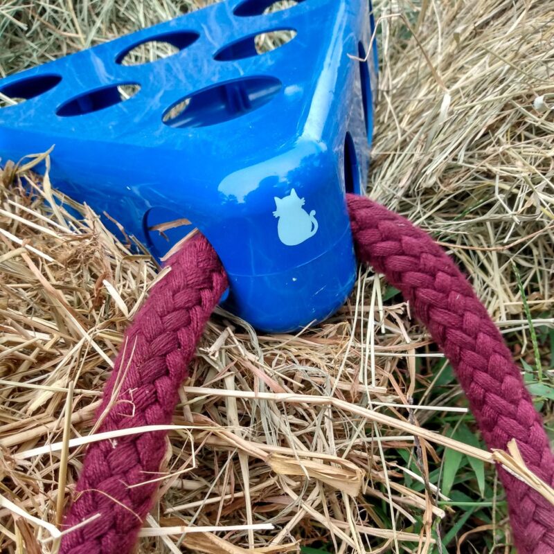 The hay toy close up with lead rope attached to top of the toy.