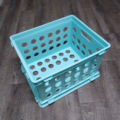 A light blue Sterilite file storage crate made of plastic with perforated sides.