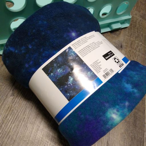 A roll of blue blanket fleece in store packaging.