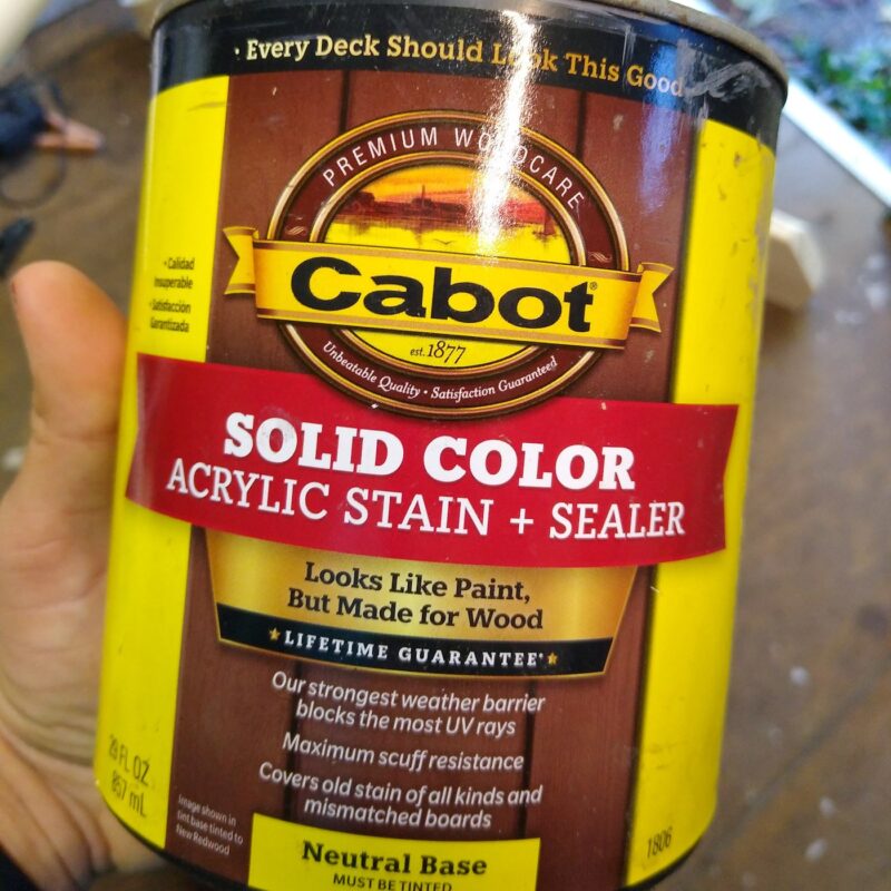 A quart container of Cabot brand solid color acrylic wood stain and sealer.