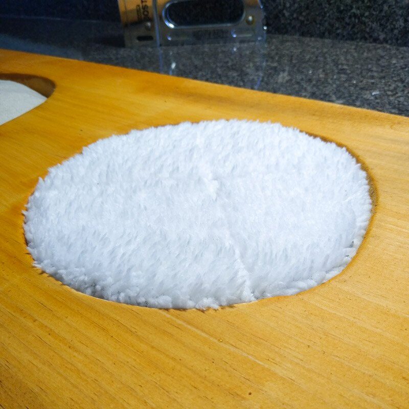 Close up of round fabric scent pad made of white sherpa fleece. 