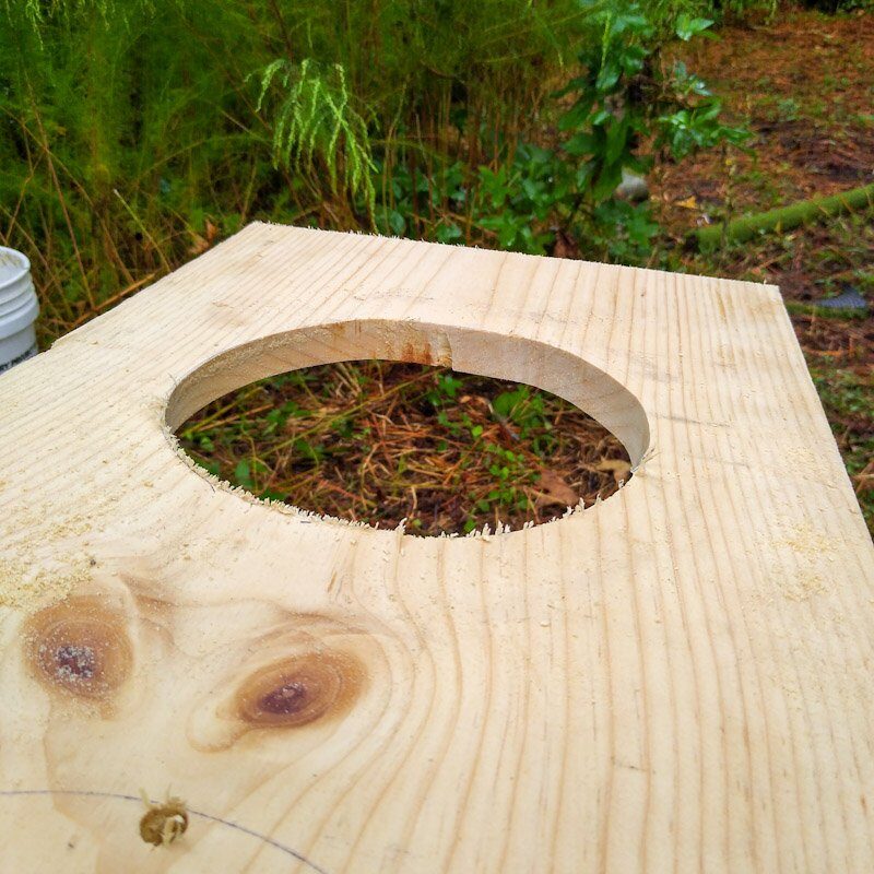 A round hole in a wooden board.