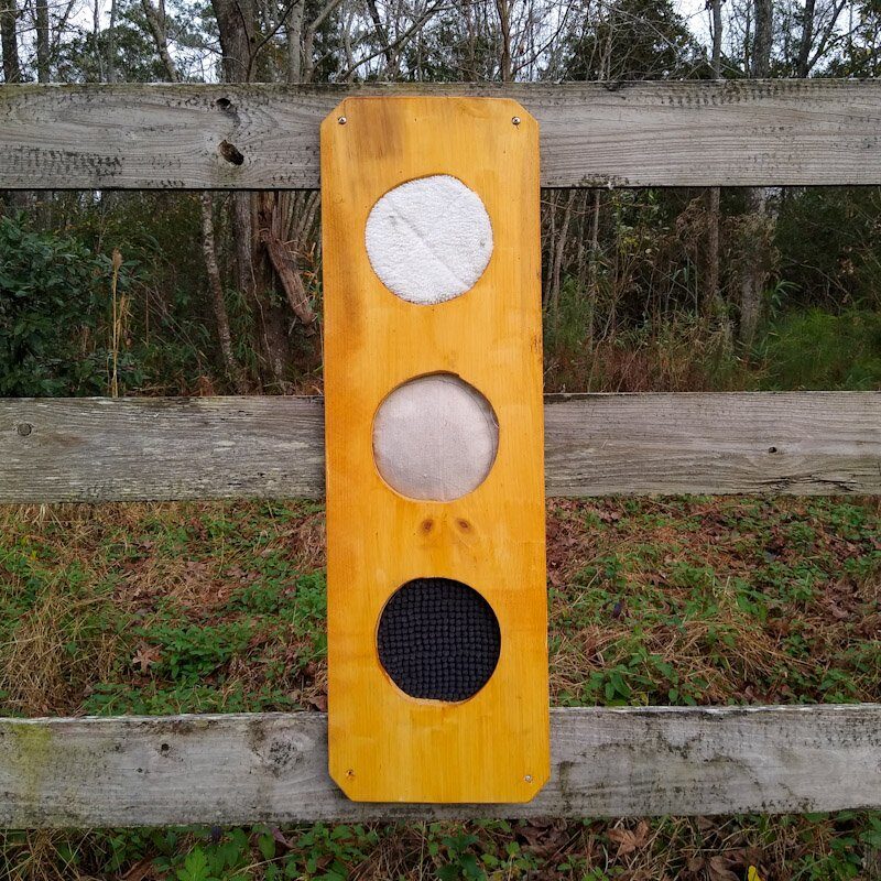 DIY scent board for horses installed on a wooden pasture fence for scent enrichment. 