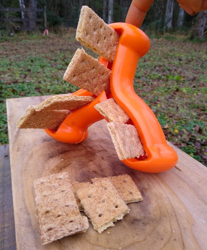 Orange rubber Wishbone toy full of graham crackers.