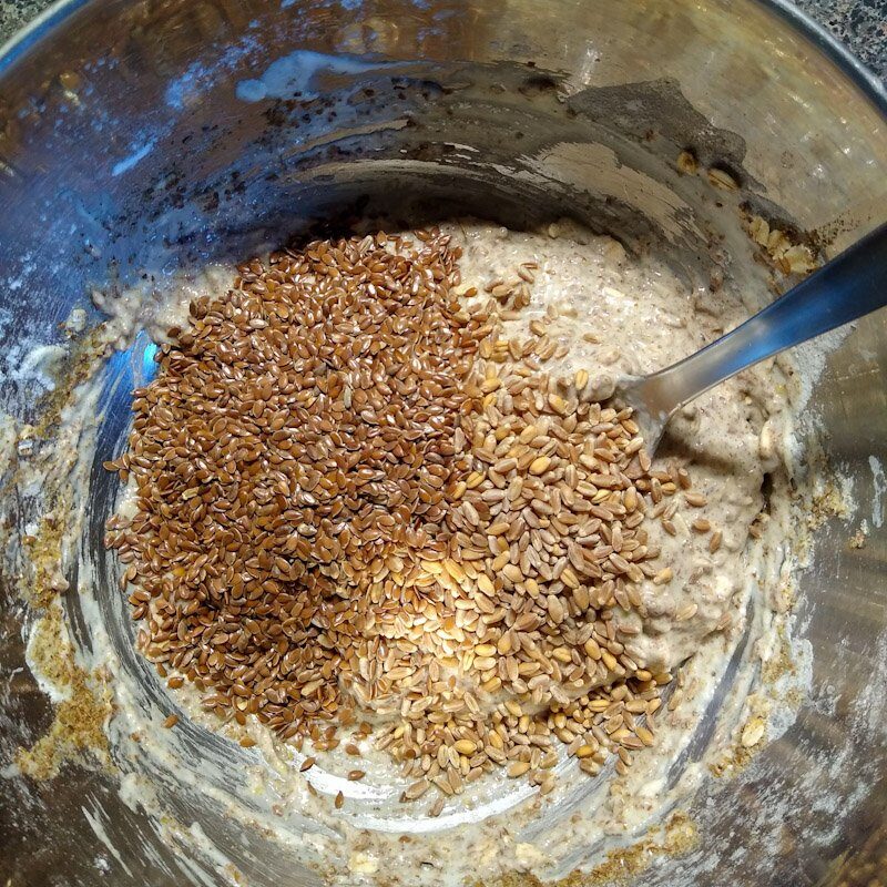 Bowl seen from above showing DIY likit refill ingredients. Clockwise from left to right, wheat berries, oatmeal, whole flax