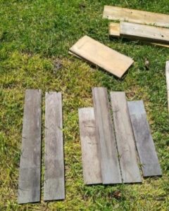 Reclaimed wood laid out on grass