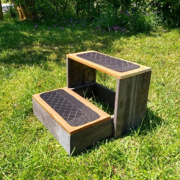 Finished DIY two step mounting block for horses on a grassy background.