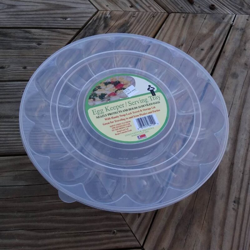 Empty DIY egg tray slow feeder with lid in place showing original purchase label.