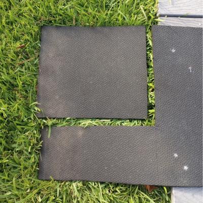 A cutout section of black rubber mat inset in the leftover pieces of mat