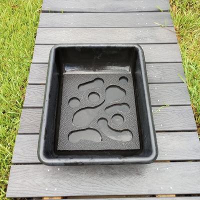 Completed DIY horse stall mat slow feeder insert in a black mixing pan on a gray decking background