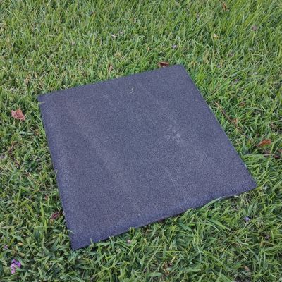 A black square rubber traction mat.