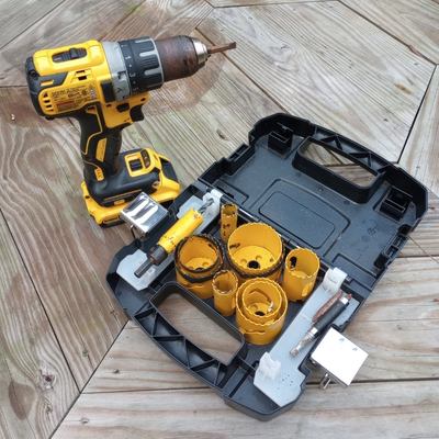 A yellow and black DeWalt drill and hole saw kit.