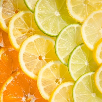 Close up of sliced lemons, limes, and oranges.