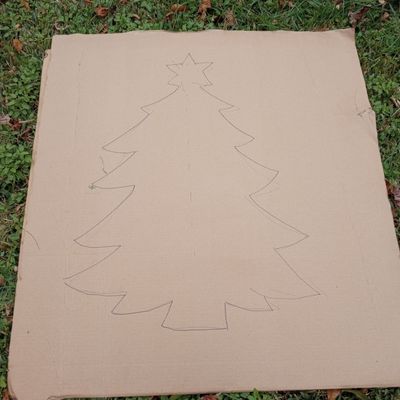 A simple holiday tree shape drawn onto a piece of cardboard.
