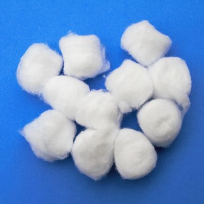 Image of white cotton balls on blue background.