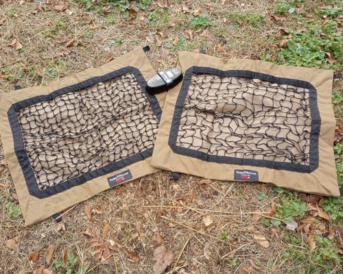 Two empty Hay Pillows for horses flat on the ground with two mesh sizes